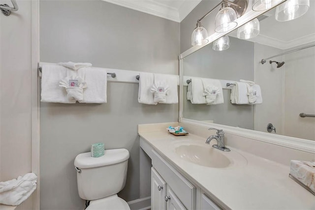 bathroom with vanity, ornamental molding, and toilet