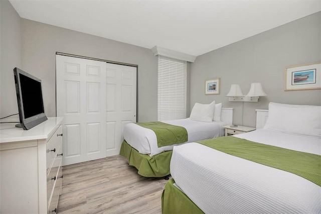 bedroom with a closet and light wood-style floors