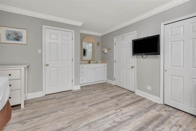 unfurnished bedroom featuring light wood-style floors, baseboards, and ornamental molding