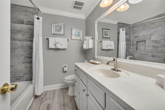 full bathroom with vanity, ornamental molding, wood finished floors, toilet, and baseboards