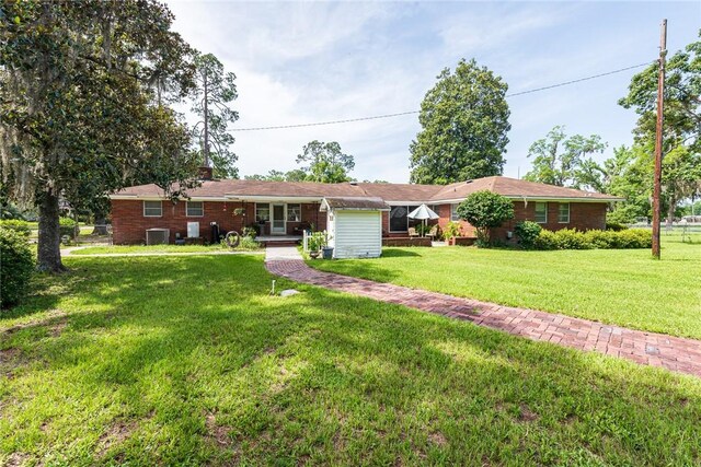 177 Pinewood St, Folkston, GA 31537 - ranch-style home with a front lawn and a chimney