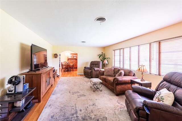 177 Pinewood St, Folkston, GA 31537 - living room featuring arched walkways and light wood-style flooring