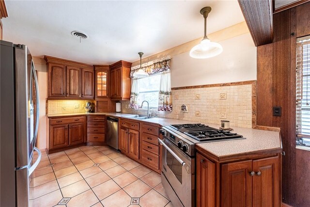 177 Pinewood St, Folkston, GA 31537 - kitchen with appliances with stainless steel finishes, brown cabinets, light countertops, and light tile patterned floors