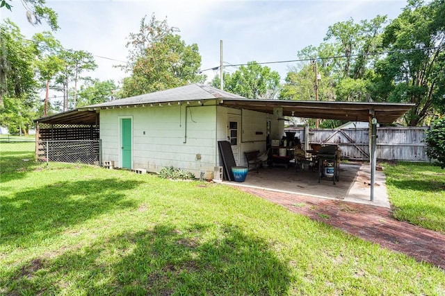 177 Pinewood St, Folkston, GA 31537 - back of property featuring a patio area and an attached carport
