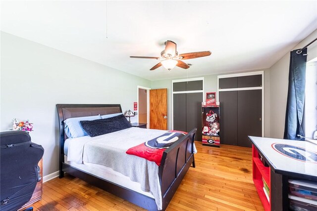 177 Pinewood St, Folkston, GA 31537 - bedroom with multiple closets, light wood-style flooring, and a ceiling fan