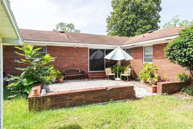 177 Pinewood St, Folkston, GA 31537 - back of house with brick siding, a patio area, and a shingled roof