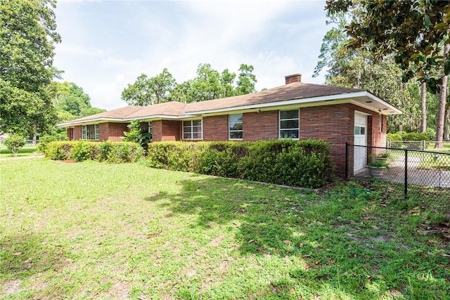 177 Pinewood St, Folkston, GA 31537 - view of front of property featuring a chimney, brick siding, and an attached garage