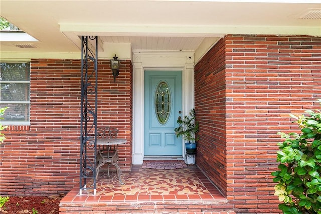 177 Pinewood St, Folkston, GA 31537 - view of exterior entry with brick siding and a porch