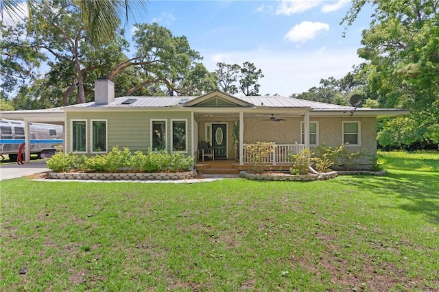 105 Ledbetter Ave, Saint Simons Island, GA 31522 - single story home with covered porch, a ceiling fan, a front yard, a chimney, and a carport
