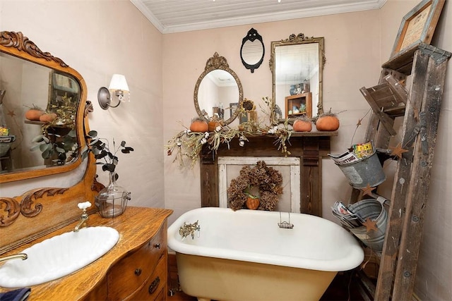 bathroom with a freestanding tub, crown molding, and vanity