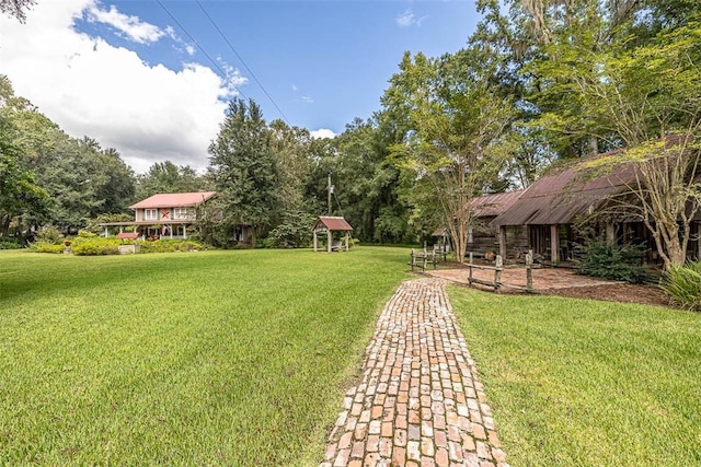 view of property's community with a lawn