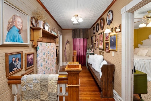 sitting room featuring a ceiling fan, dark wood finished floors, and crown molding