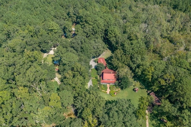 birds eye view of property with a view of trees