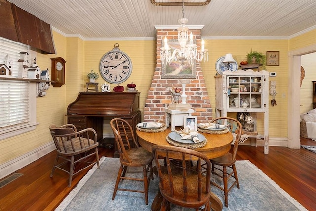 dining room featuring visible vents, wood finished floors, and ornamental molding