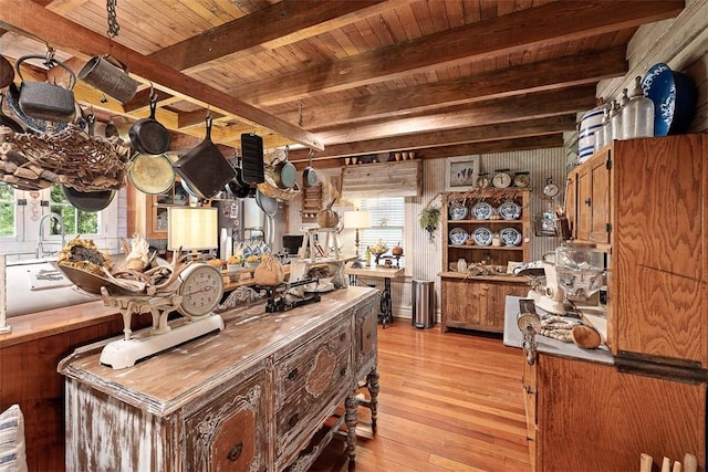 kitchen with wooden ceiling, a kitchen island, beam ceiling, and light wood-style floors