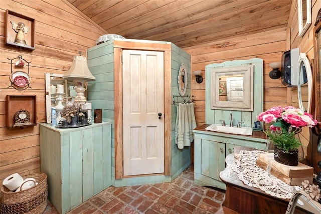 interior space with brick floor, wood ceiling, wooden walls, and vanity