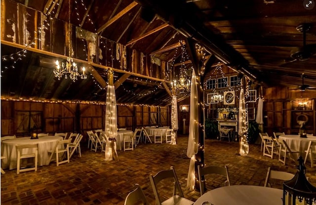 wine area featuring lofted ceiling and a chandelier