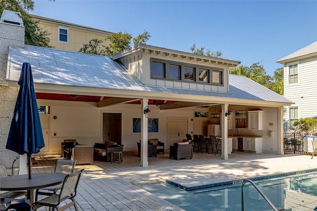 rear view of house with a fenced in pool, outdoor lounge area, ceiling fan, and a patio area