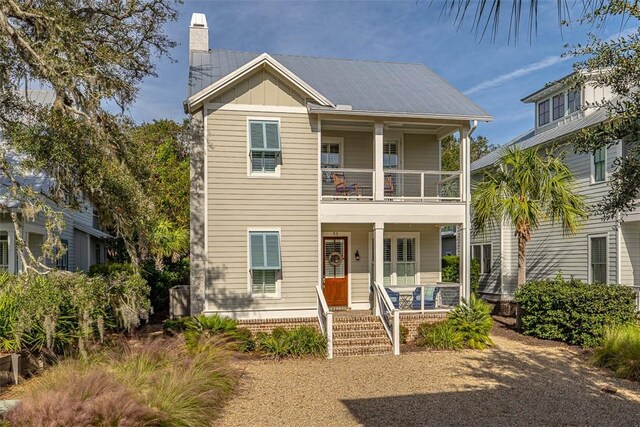 view of front of home featuring covered porch and a balcony