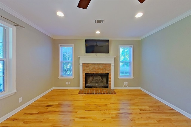 unfurnished living room with crown molding, a ceiling fan, light wood-style flooring, and visible vents