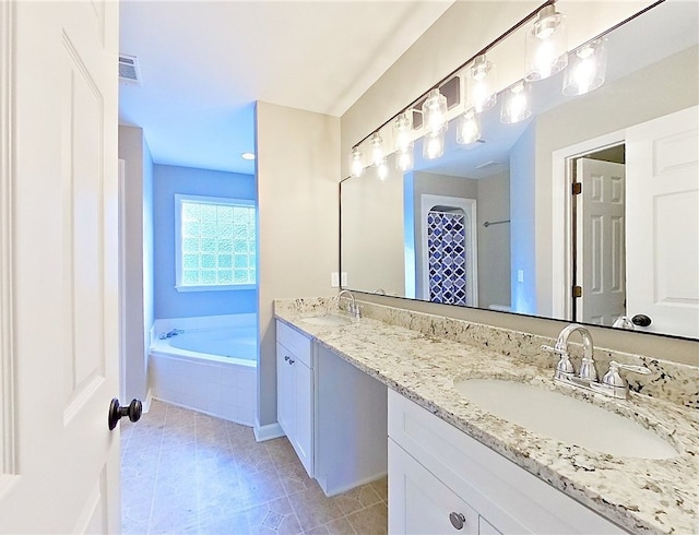 full bath featuring visible vents, double vanity, a bath, tile patterned floors, and a sink