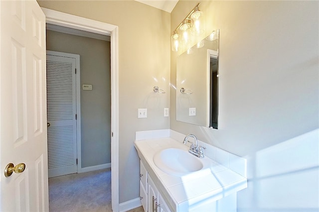 bathroom with vanity and baseboards