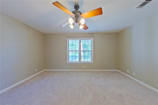 unfurnished room with baseboards, visible vents, light carpet, and ceiling fan