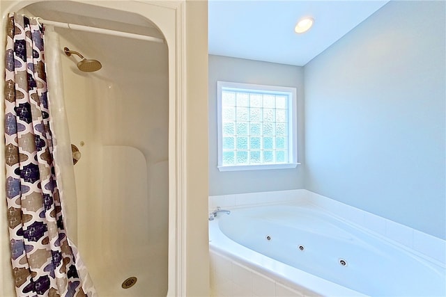 full bath with a whirlpool tub and a stall shower