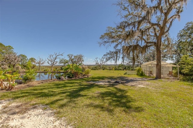 view of yard featuring an outbuilding and a water view