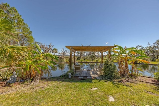 view of dock featuring a pergola, a water view, and a lawn