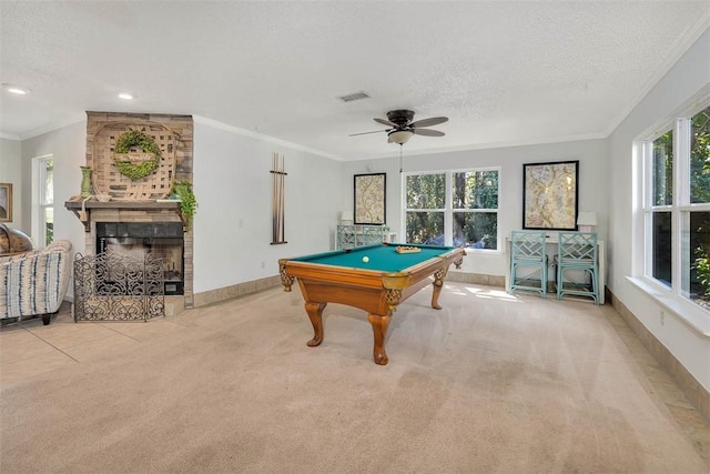 recreation room with a fireplace, plenty of natural light, a textured ceiling, and pool table