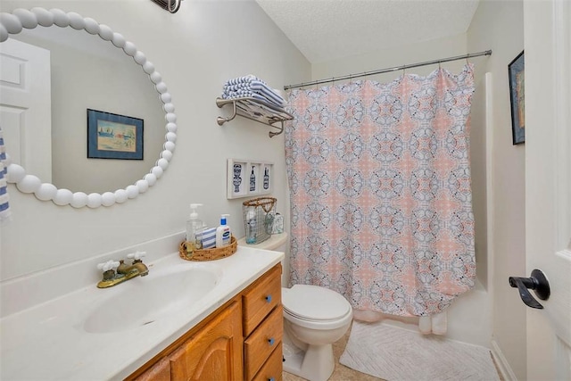 bathroom with vanity, a textured ceiling, and toilet