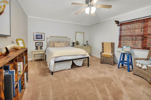 bedroom with ceiling fan, crown molding, light carpet, and a textured ceiling