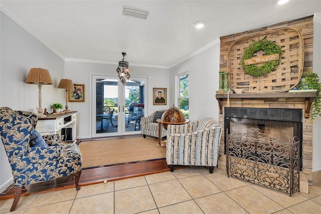 tiled living room with a textured ceiling, a large fireplace, and crown molding