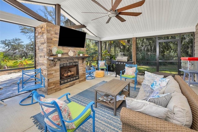 exterior space featuring ceiling fan, an outdoor stone fireplace, and vaulted ceiling