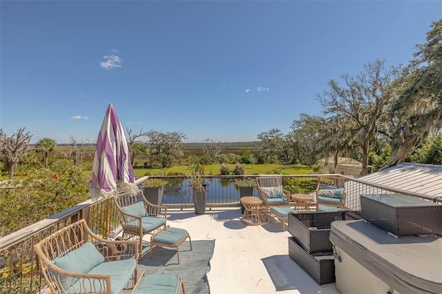 view of patio / terrace with an outdoor living space and a water view