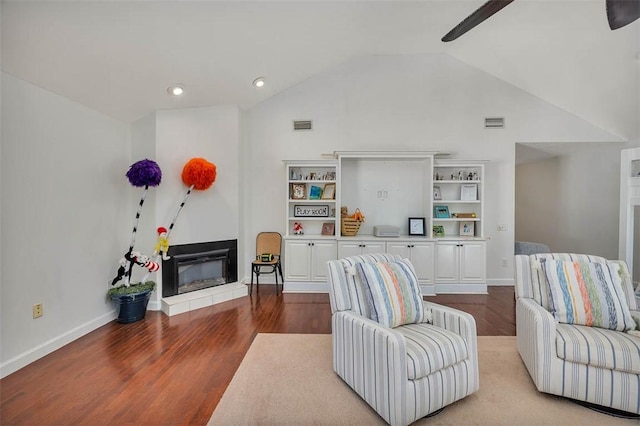 living room featuring ceiling fan, light hardwood / wood-style flooring, and lofted ceiling