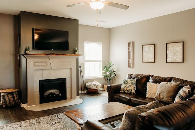 272 NE Whippoorwill Way, Ludowici, GA 31316 - living area with a tiled fireplace, baseboards, ceiling fan, and wood finished floors
