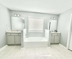 272 NE Whippoorwill Way, Ludowici, GA 31316 - bathroom with tile patterned floors, two vanities, and a bath