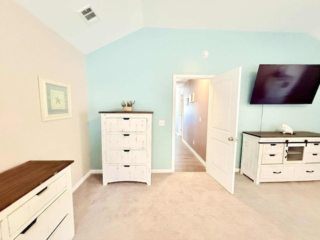 272 NE Whippoorwill Way, Ludowici, GA 31316 - bedroom with visible vents, baseboards, lofted ceiling, and light carpet