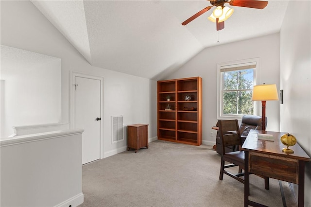 home office with light carpet, a textured ceiling, vaulted ceiling, and ceiling fan