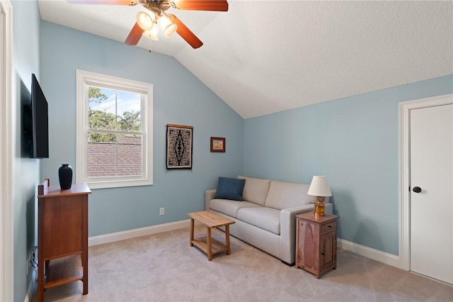 carpeted living room featuring ceiling fan and lofted ceiling