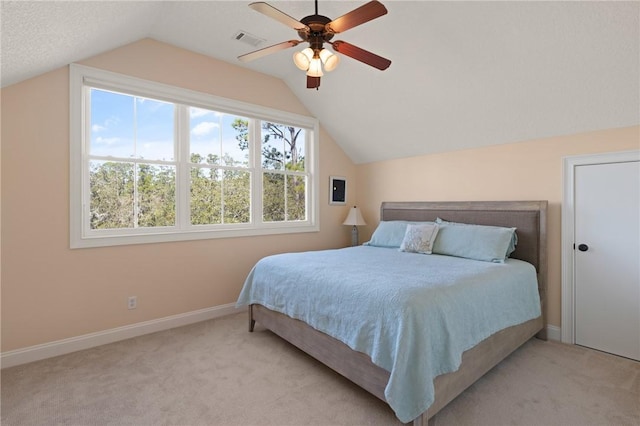 bedroom featuring ceiling fan, light colored carpet, and lofted ceiling