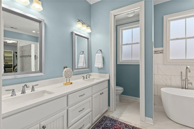 bathroom with crown molding, tile walls, vanity, a bath, and toilet