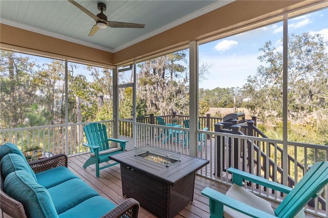 sunroom / solarium featuring ceiling fan