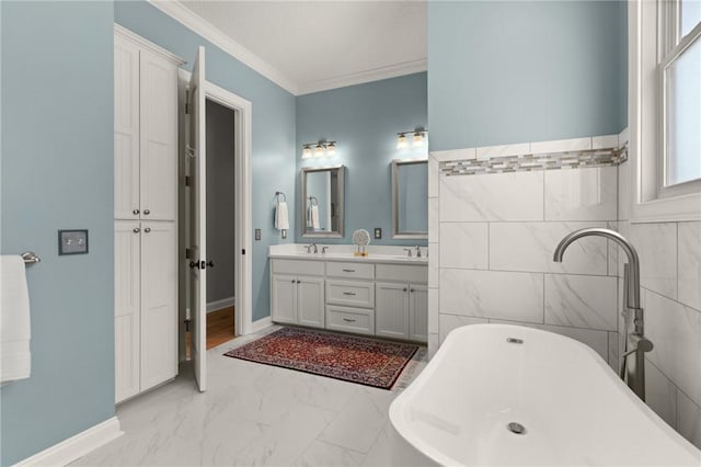 bathroom with vanity, crown molding, and a tub