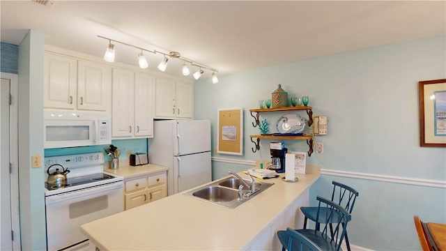1175 N Beachview Dr Unit 389, Jekyll Island, GA 31527 - kitchen featuring open shelves, a peninsula, white appliances, white cabinets, and a sink