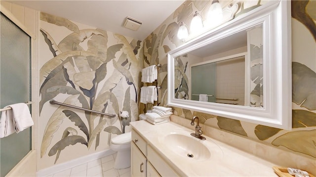 bathroom with tile patterned floors, vanity, toilet, and a shower with door