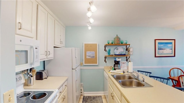 1175 N Beachview Dr Unit 389, Jekyll Island, GA 31527 - kitchen featuring white cabinets, a sink, white appliances, light countertops, and rail lighting