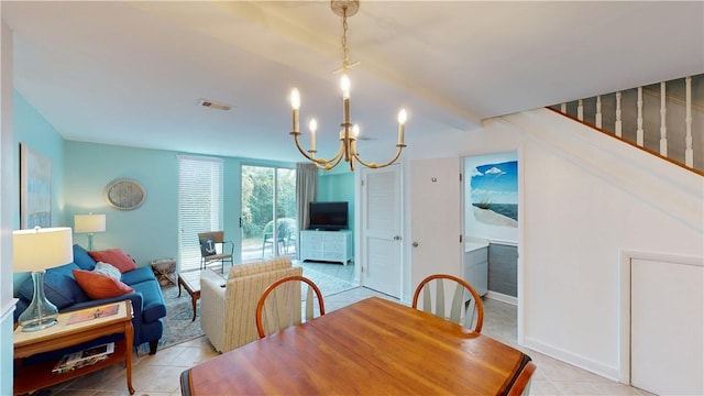 tiled dining space featuring a chandelier